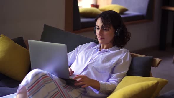 Stylish Brunette Woman Working on Laptop at Home Office
