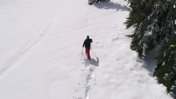 Drone Shot Of Snowshoeing Deep In Forest Mountain Backcountry With Fresh Powder Snow alt