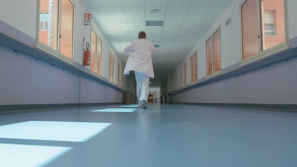 Doctor Walking Down the Hospital Corridor