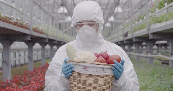 Middle Shot of Female Biologist or Agronomist Admiring Fresh Organic Vegetables in Basket. Portrait