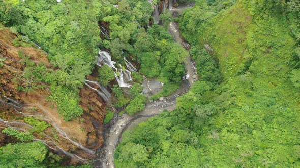 Flying over the river in mountain gorge tropical forest