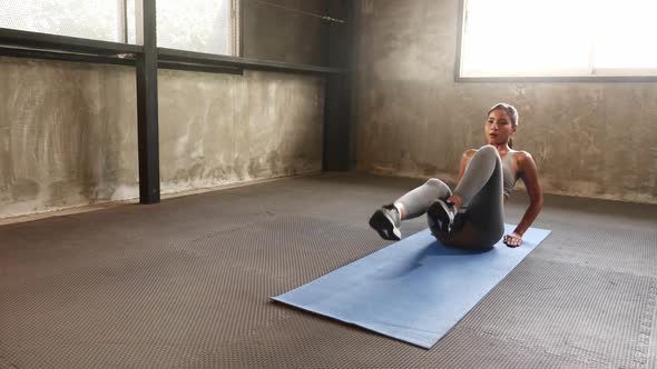 Sporty woman exercising building muscles at the gym