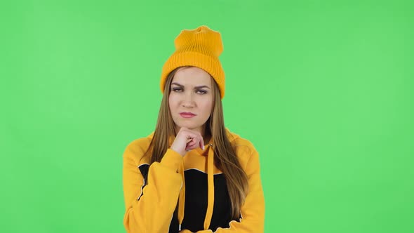 Portrait of Modern Girl in Yellow Hat Is Focused Thinking About Something, No Idea