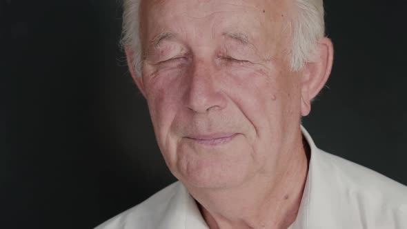 Portrait of Senior Man with Dreamy Look on Background