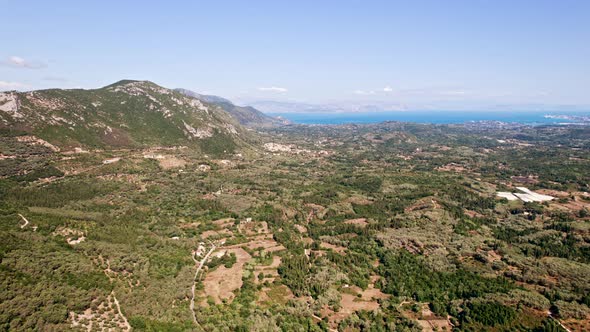 Camera Flying Forward Over Summer Landscape of South Island in Italy  Forests Villages Mountains