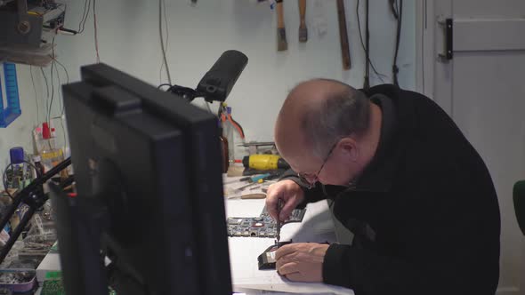 a Man Repairing a Laptop