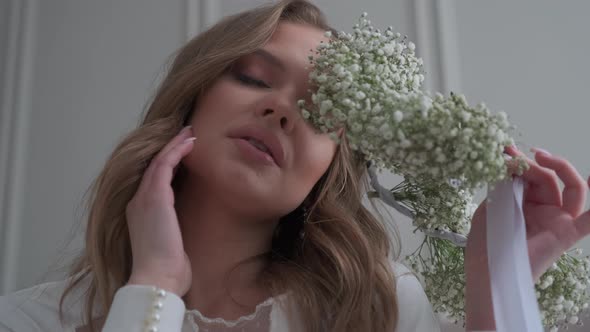 Portrait of a Sexy Bride with a Wreath in Her Hands