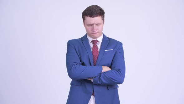 Stressed Young Businessman Looking Angry with Arms Crossed