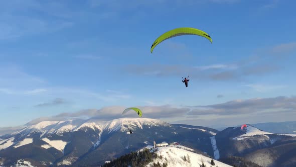 Freedom Adventure of Paragliding Flying Above Winter Alpine Mountains, Free Flight Extreme Sport