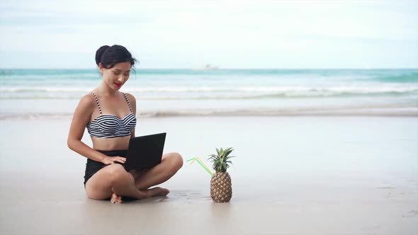 Girl Drinking Pineapple Near the Sea