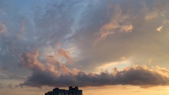 Cumulus and stratus clouds in golden light at the sunset, Timelapse