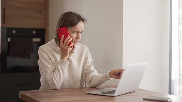 Upset Young Woman Using Online Banking Service Problem with Blocked Credit Card Using Laptop