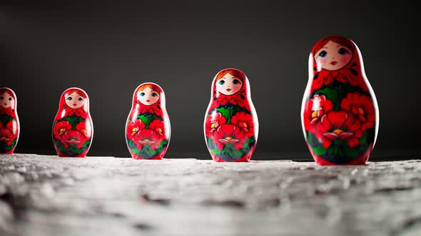 Matryoshka dolls placed in a circle. A camera follows one babushka after another