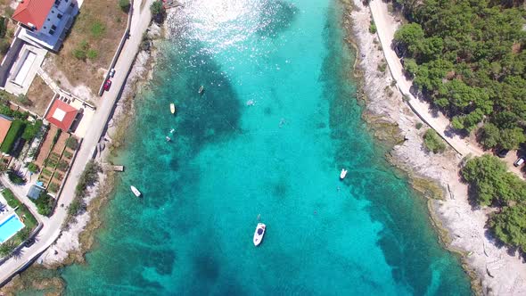 Aerial view of people swimming in turquoise bay on the island of Brac, Croatia