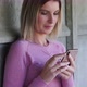 Young Blonde Caucasian Sporty Woman Wearing Pink Sports Apparel Uses Mobile Phone in Fitness Center - VideoHive Item for Sale