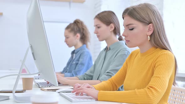 Hardworking Creative Female Team Working on Desktop and Laptop