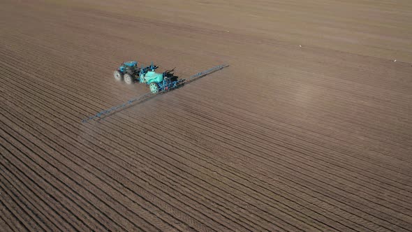 Aerial view of a tractor that irrigates agricultural field