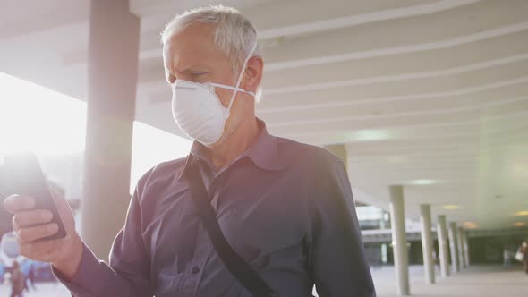 Caucasian man out and about in the street wearing on a face mask against coronavirus