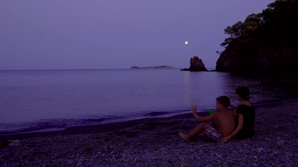 Mom with Her Son By the Sea at Night