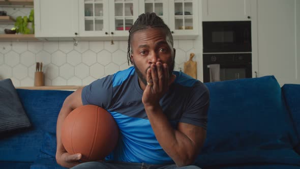 Excited African American Basketball Fan Making Winning Closed Fist Gesture