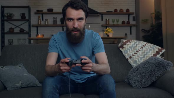 Bearded man playing video games. 