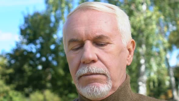 Smiling Mature Gentleman With Bunch of Field Flowers Standing Park Waiting Date