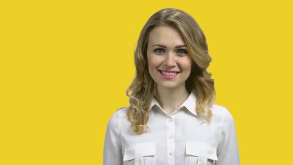 Close Up of Smiling Business Woman on Yellow Background