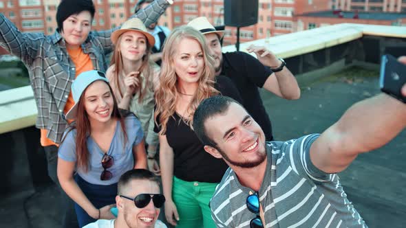 Group of Happy Student Friends in Shared Posing for Selfie Laughing Pulling Faces and Gesticulating