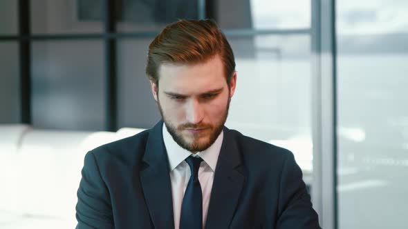 Young businessman surfing the internet using a laptop