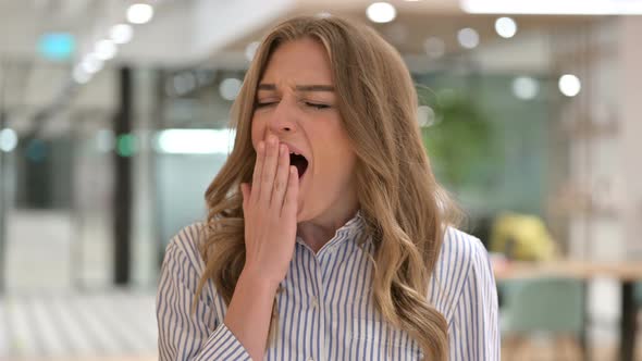 Portrait of Exhausted Businesswoman Yawning 