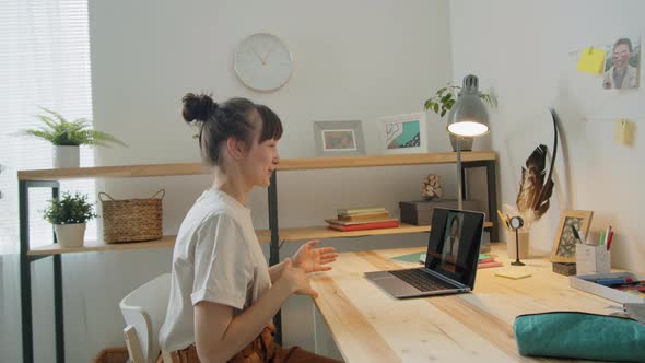 Woman Sitting at Home and Chatting on Video Call