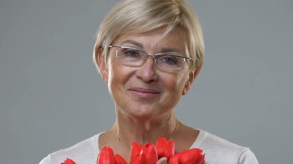 Middle-Aged Lady Enjoying Scent of Tulips, Greetings on Mother Day, Anniversary