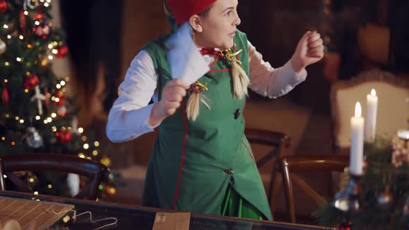 Curious elf looking at envelopes in the decorated room.