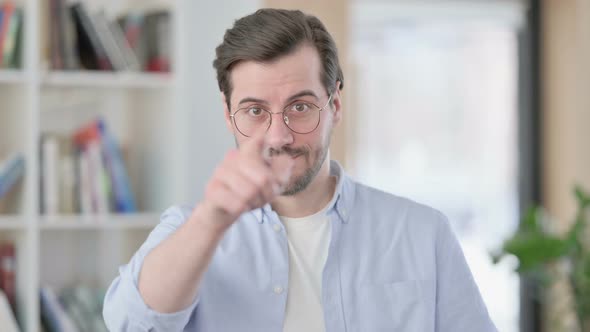 Portrait of Man in Glasses Pointing at Camera Inviting
