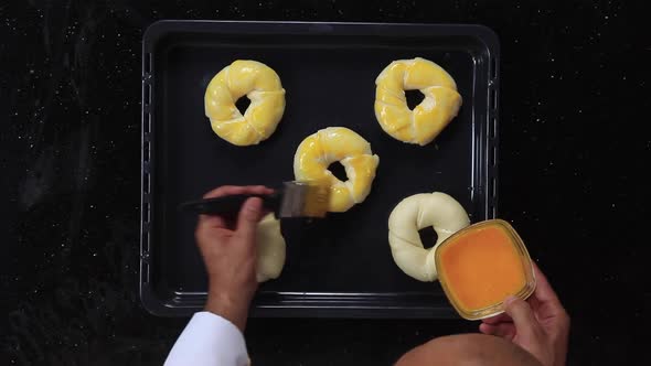 Chef Greases the Cookie Dough with Egg Yolks Using a Brush