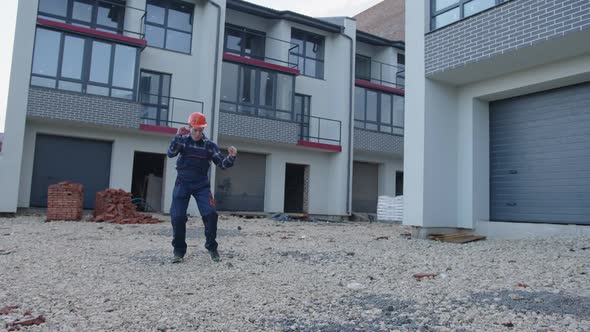 Man Starts to Dancing on a House Construction