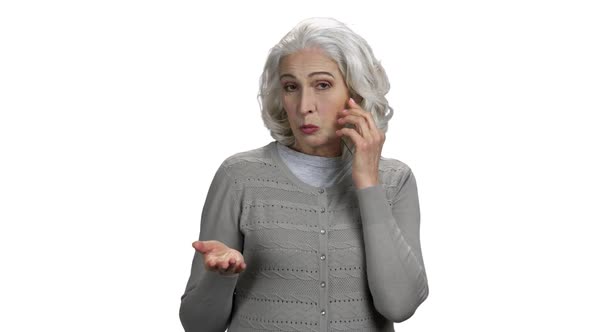 Mature Woman Talking on Phone and Looking at Camera