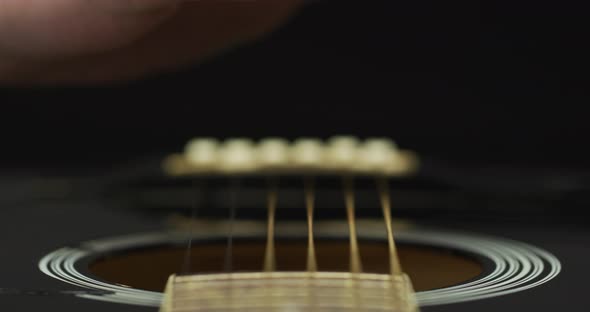 Extreme close up of fingers strumming strings