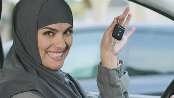 Muslim Woman Showing Keys, Excited With Car Purchase, Driving Gender Equality