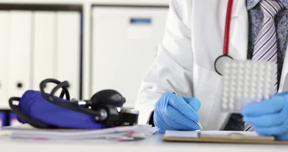 Doctor Holding Blister with Pills and Writing Prescription  Movi