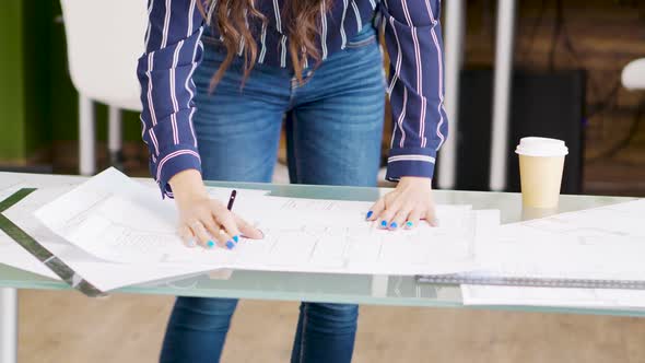 Close Up Hands of Female Architect Drawing on Blueprints