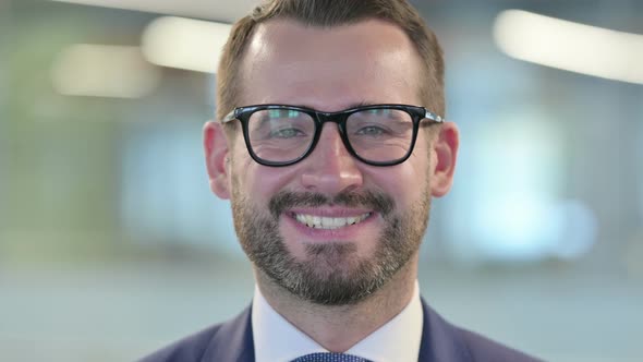 Close Up of Middle Aged Businessman Smiling at Camera