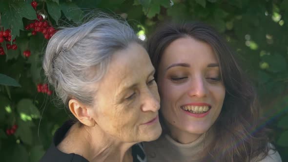 Happy Senior Mother in Eyeglasses is Hugging Her Adult Daughter the Women are Enjoying Together