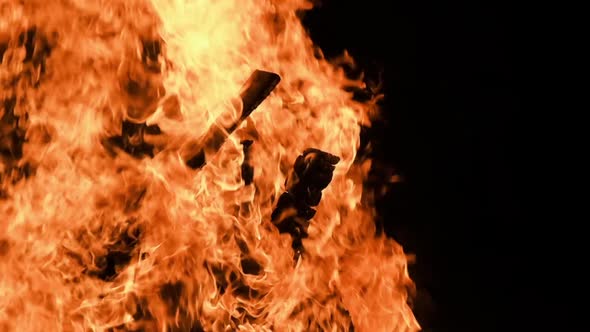 Big Bonfire Burns at Night in Slow Motion on a Black Background