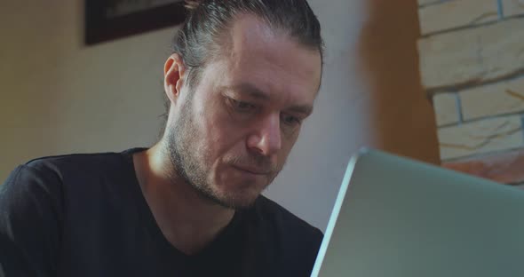 Close Up Middleaged Man Working on Laptop Seriously Looking on Screen Indoors