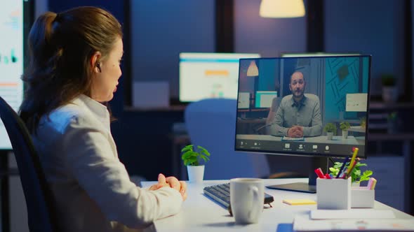 Woman Freelancer Discussing with Client on Video Call at Midnight