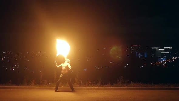 Young Blond Male Breathes Out Large Stream of Fire Making Fireball