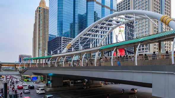 day to night Time-lapse of public sky walk and traffic at Chong Nonsi sky train station, Bangkok