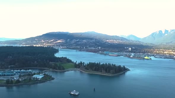 Cinematic drone shot of a beautiful city and mountain range.