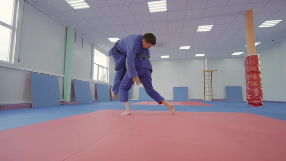 Male and Female Athletes Practicing Jujutsu in Martial Arts Gym